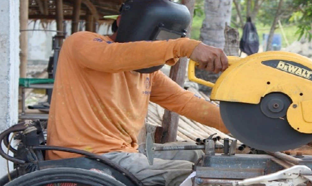 Man in a wheelchair working.